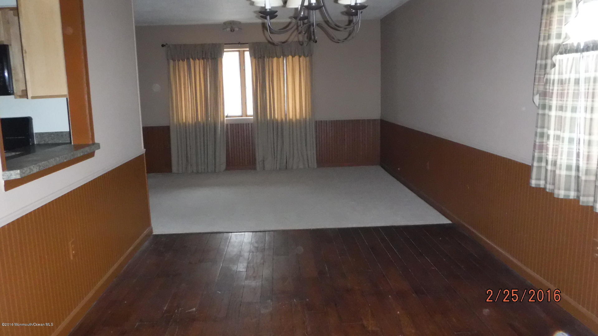 108 Toggle Road Manahawkin, NJ 08050 - Photo 7 of 11 an empty room with wooden floor and windows