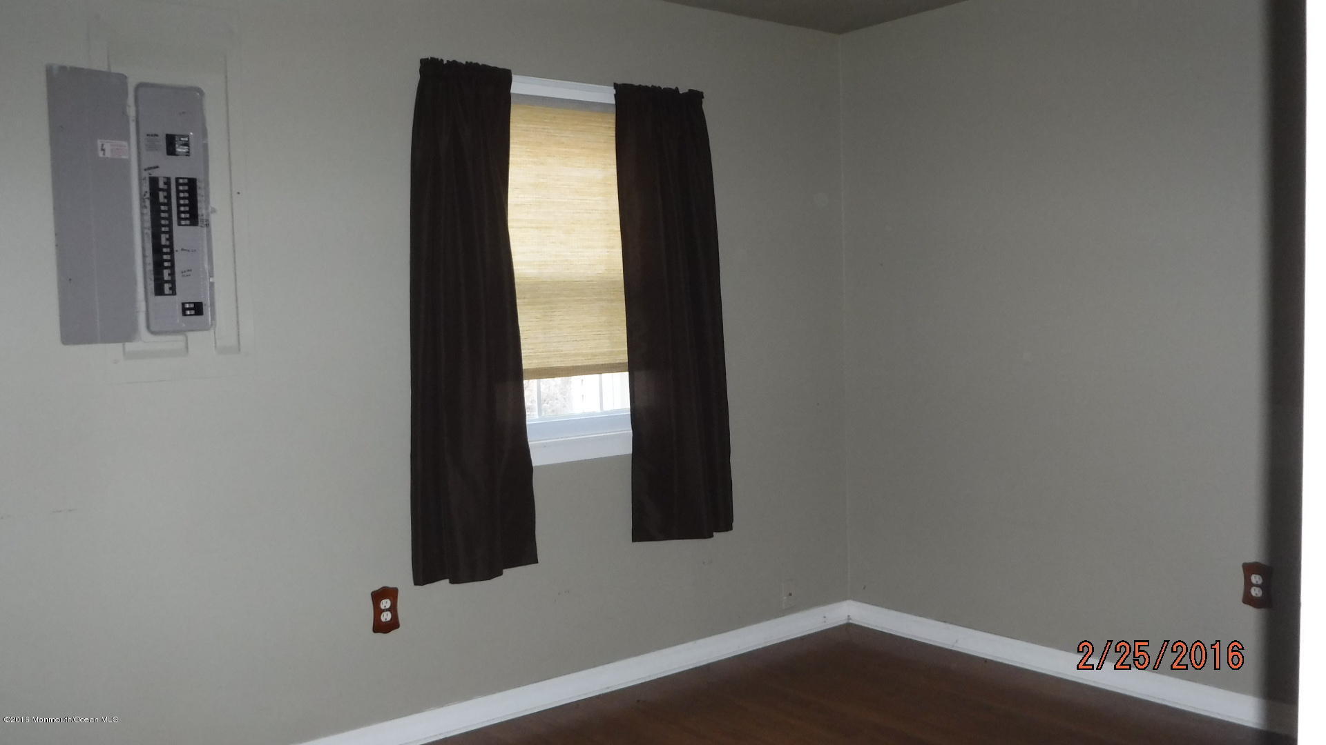 108 Toggle Road Manahawkin, NJ 08050 - Photo 10 of 11 an empty room with wooden floor and windows
