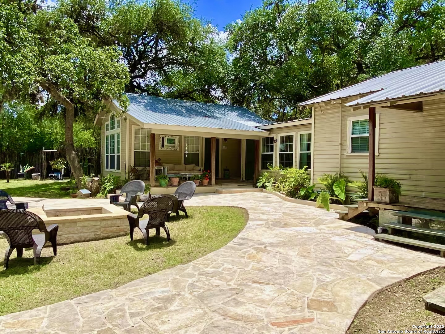 512 County Road 348 Concan, TX 78838 - Photo 3 of 39 a view of a house with backyard sitting area and garden