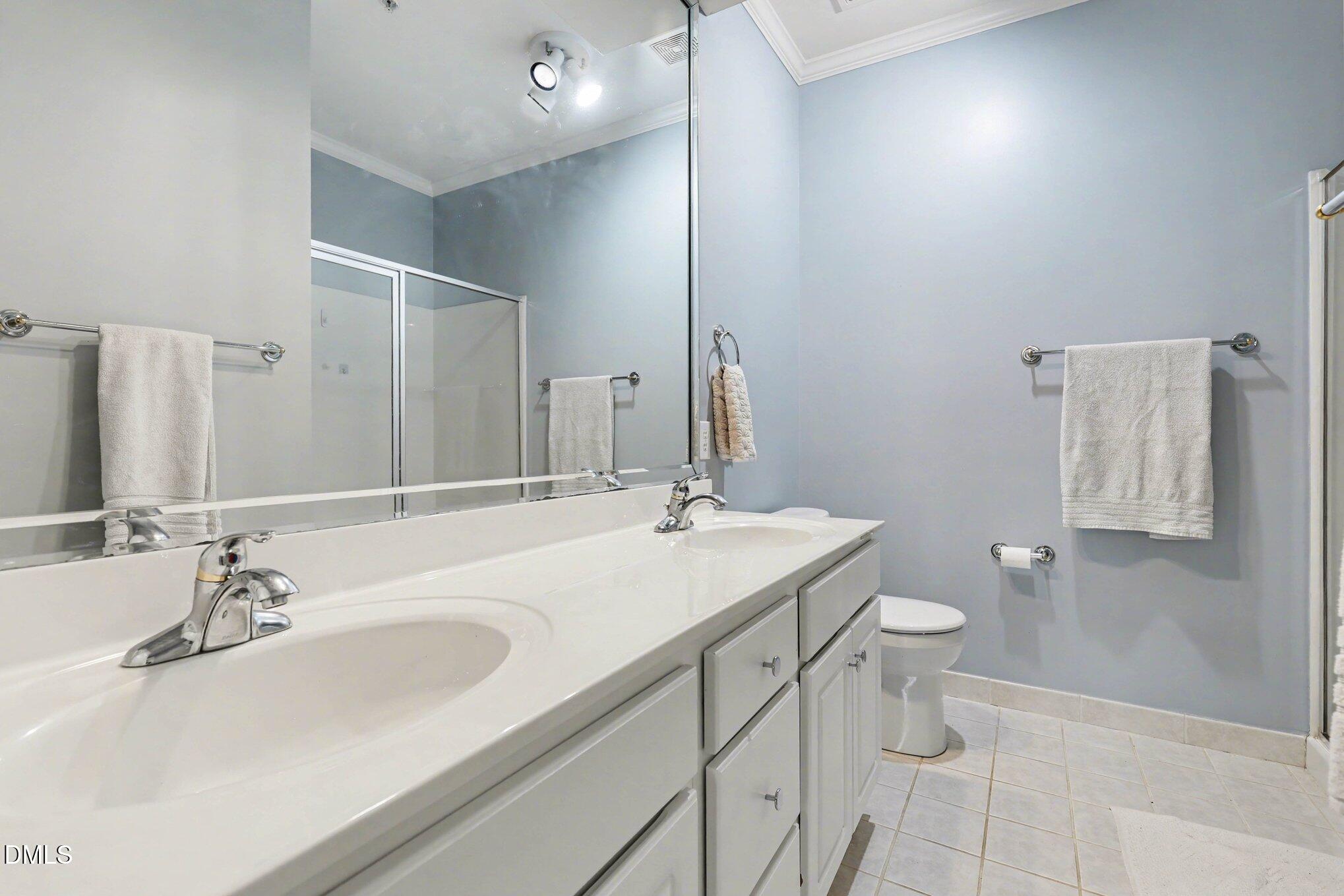 7530 Lead Mine Road, Unit 202 Raleigh, NC 27615 - Photo 12 of 36 a bathroom with a sink toilet and mirror