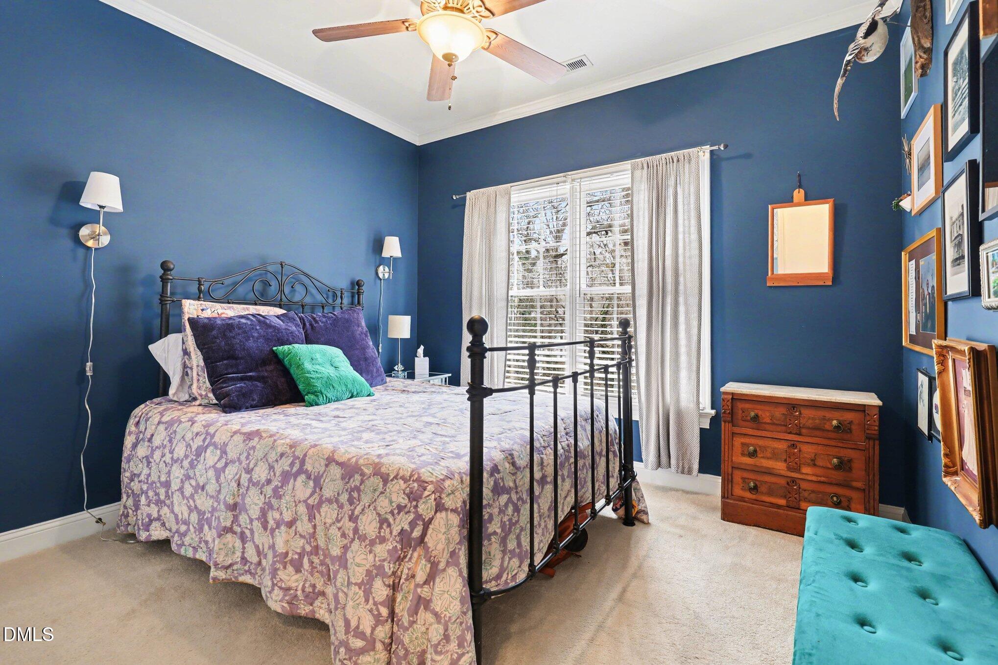 7530 Lead Mine Road, Unit 202 Raleigh, NC 27615 - Photo 14 of 36 a bedroom with a bed and a chandelier