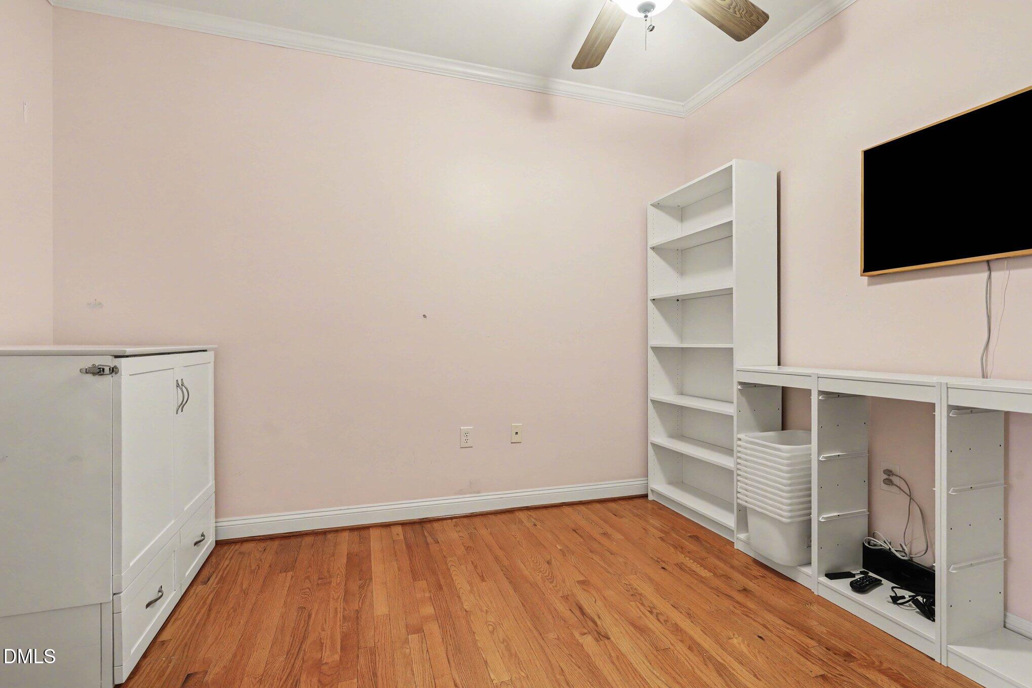 7530 Lead Mine Road, Unit 202 Raleigh, NC 27615 - Photo 20 of 36 a view of an empty room with a fireplace and a window