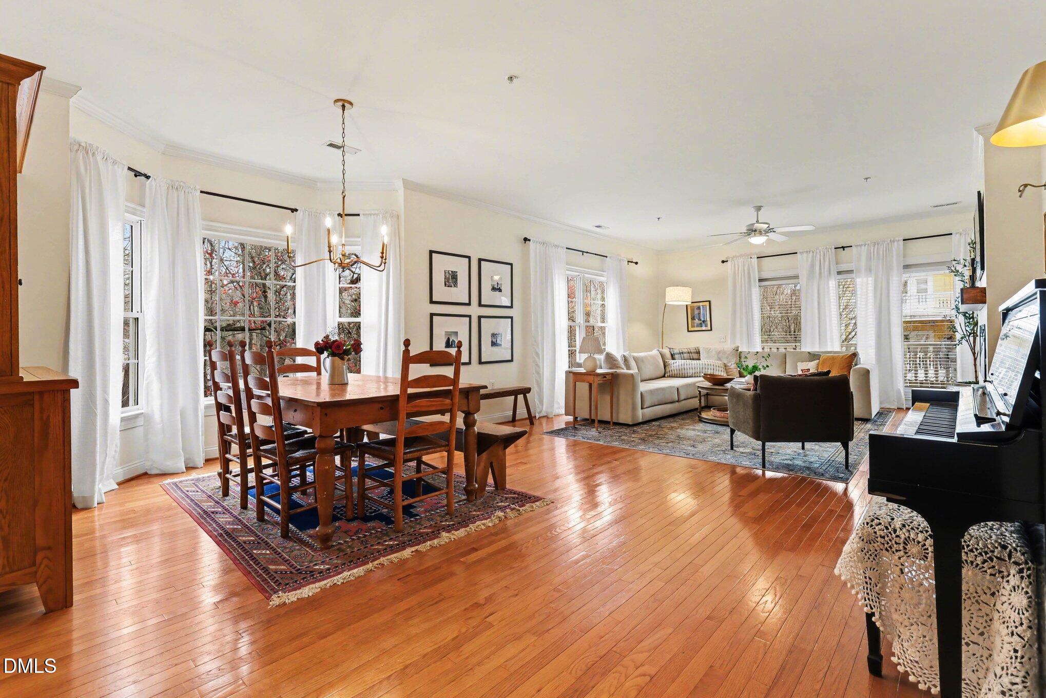7530 Lead Mine Road, Unit 202 Raleigh, NC 27615 - Photo 4 of 36 a view of a dining room with furniture window and wooden floor