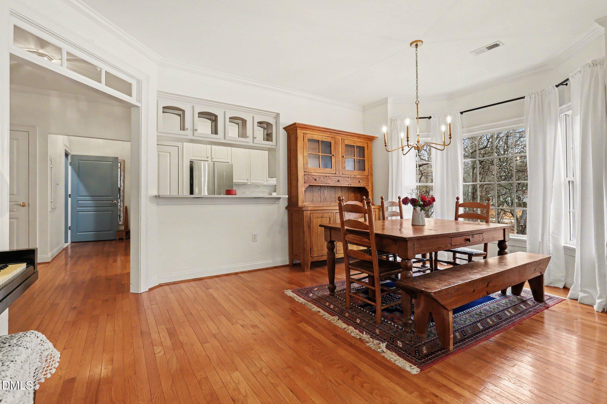 7530 Lead Mine Road, Unit 202 Raleigh, NC 27615 - Photo 6 of 36 a view of a dining room with furniture window and wooden floor