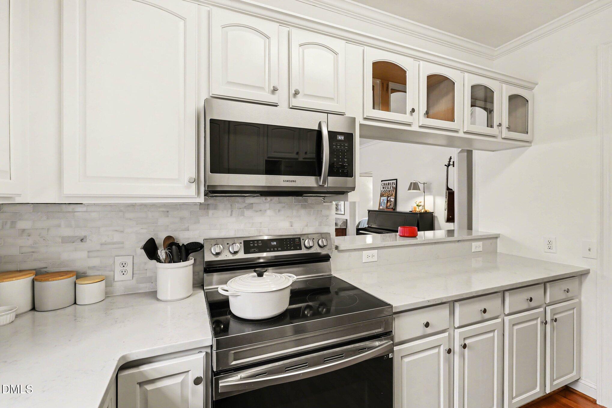 7530 Lead Mine Road, Unit 202 Raleigh, NC 27615 - Photo 8 of 36 a kitchen with stainless steel appliances granite countertop a sink a stove and microwave