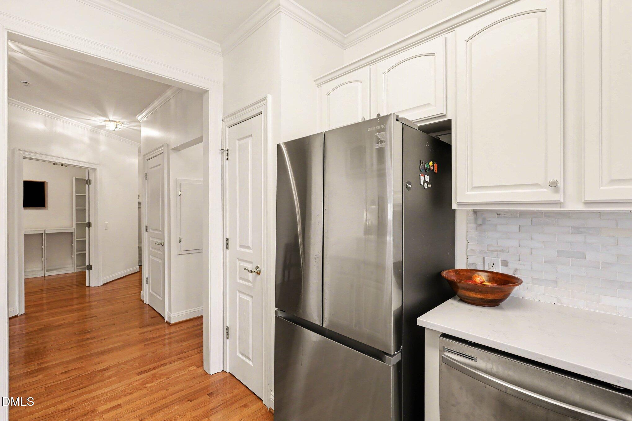 7530 Lead Mine Road, Unit 202 Raleigh, NC 27615 - Photo 9 of 36 a kitchen with stainless steel appliances a refrigerator and a stove