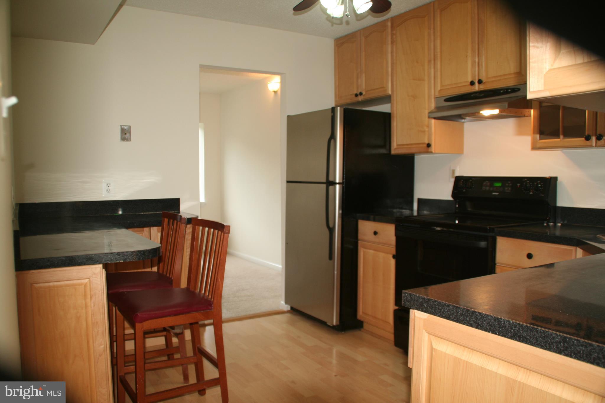2216 Springwood Drive, Unit 102 Reston, VA 20191 - Photo 2 of 19 a kitchen with stainless steel appliances granite countertop a refrigerator a stove a sink and dishwasher