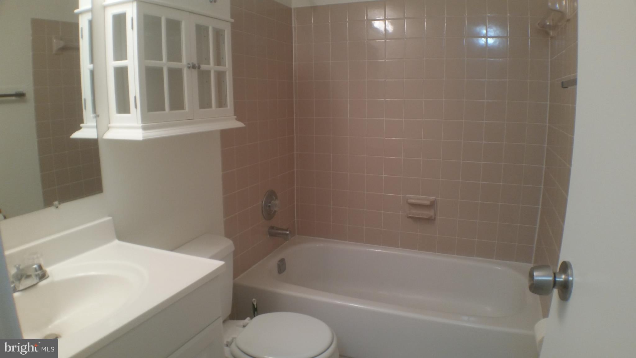 2216 Springwood Drive, Unit 102 Reston, VA 20191 - Photo 12 of 19 a bathroom with a sink a toilet and bathtub