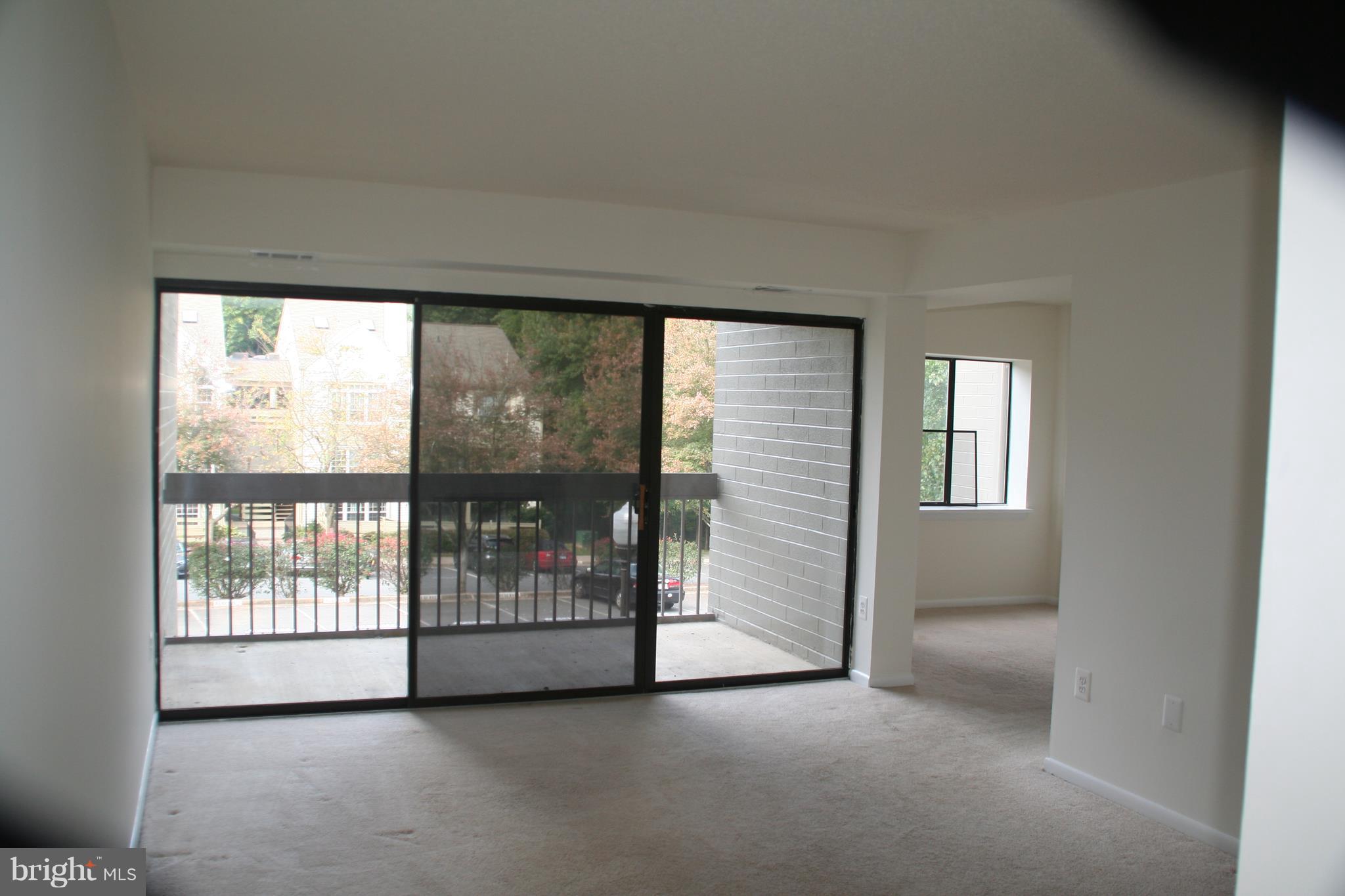 2216 Springwood Drive, Unit 102 Reston, VA 20191 - Photo 6 of 19 a view of an empty room with a window