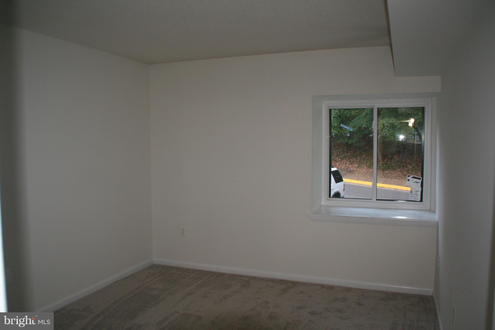 2216 Springwood Drive, Unit 102 Reston, VA 20191 - Photo 10 of 19 an empty room with a window