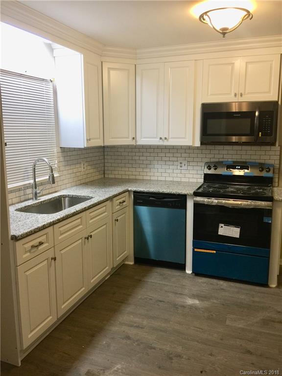 8420 Starnes Randall Road Charlotte, NC 28215 - Photo 2 of 13 a kitchen with a stove and a sink