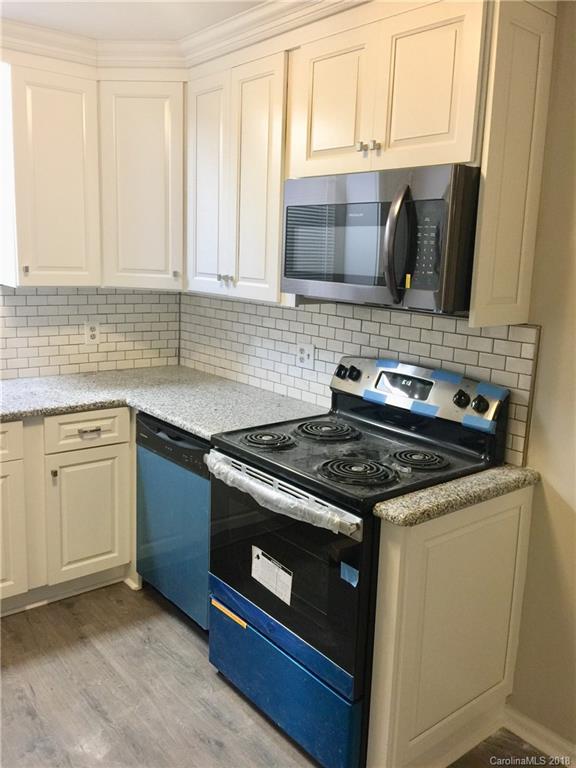 8420 Starnes Randall Road Charlotte, NC 28215 - Photo 4 of 13 a kitchen with granite countertop a stove and a sink