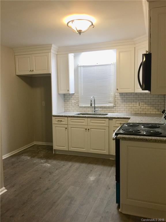8420 Starnes Randall Road Charlotte, NC 28215 - Photo 5 of 13 a kitchen with stainless steel appliances granite countertop a sink stove and cabinets