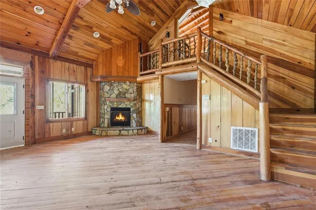 an empty room with a window and a ceiling fan