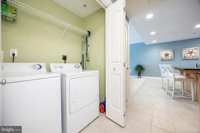a utility room with a sink a toilet and a mirror
