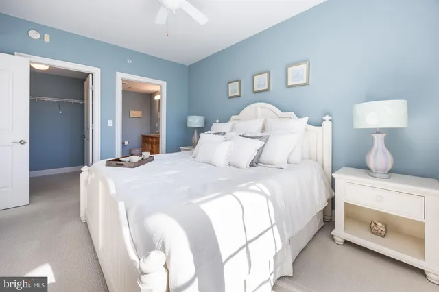 a view of a dining room and livingroom with furniture wooden floor a chandelier