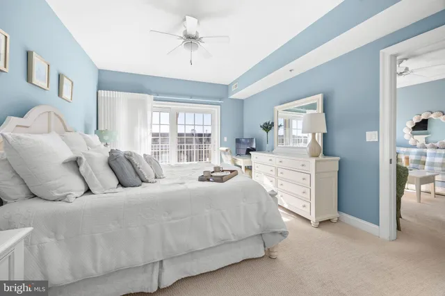 a kitchen with stainless steel appliances granite countertop a stove top oven a sink a dining table and chairs with wooden floor