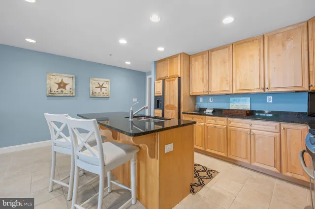 a dining room with furniture a chandelier and wooden floor