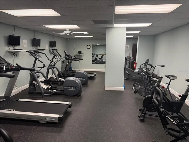 a reading room with furniture and a projector screen