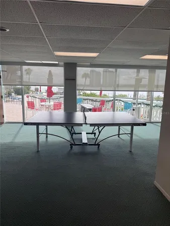 a room with pool table and windows