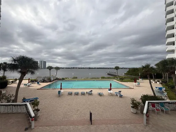 a view of swimming pool with a table and chairs