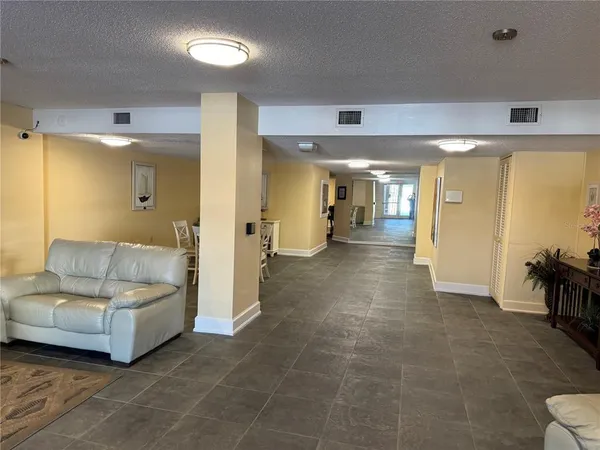 a living room with furniture and a mirror
