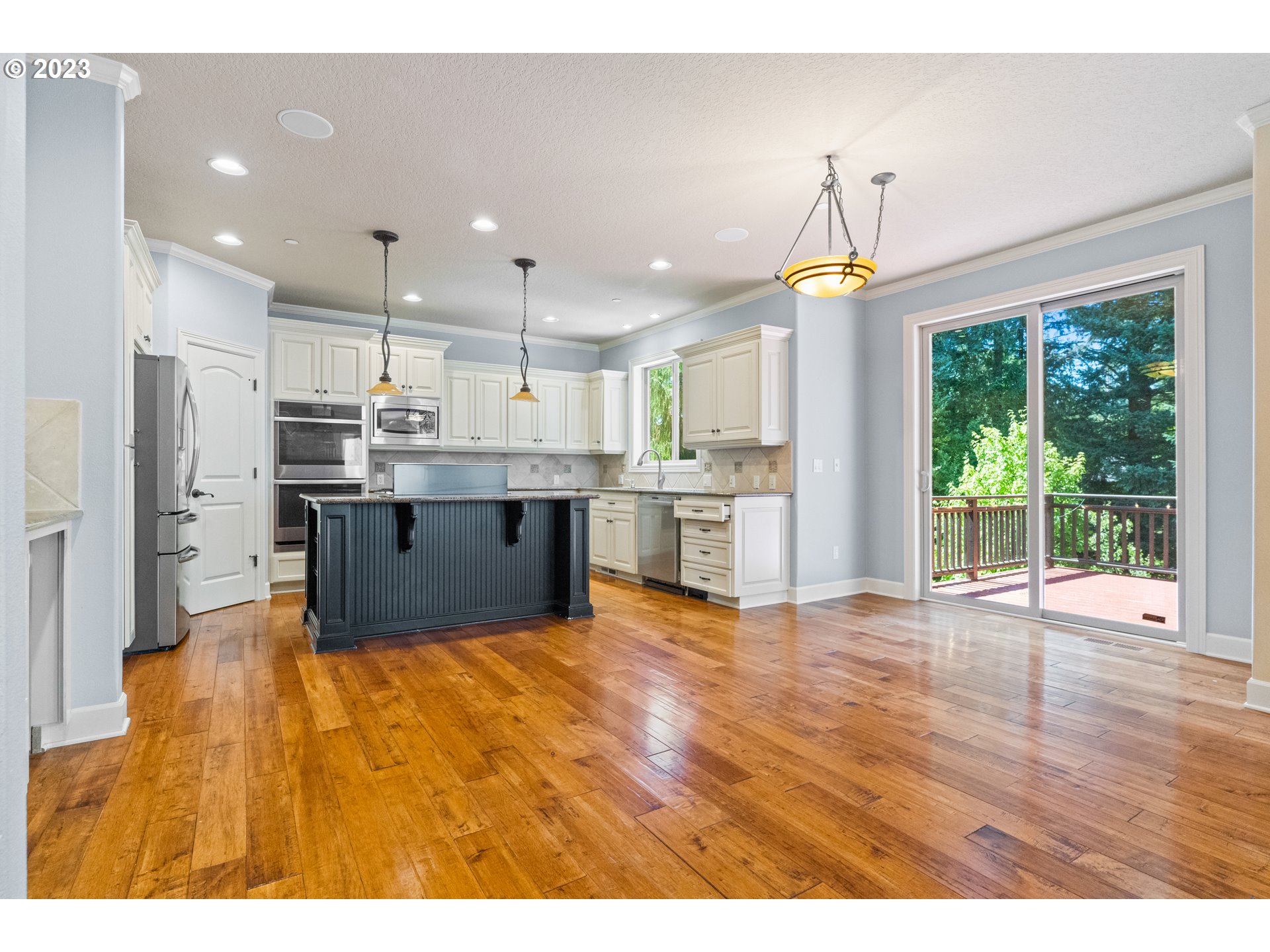 18281 Southwest Florendo Lane Beaverton, OR 97007 - Photo 12 of 47 a large kitchen with kitchen island a island in the center