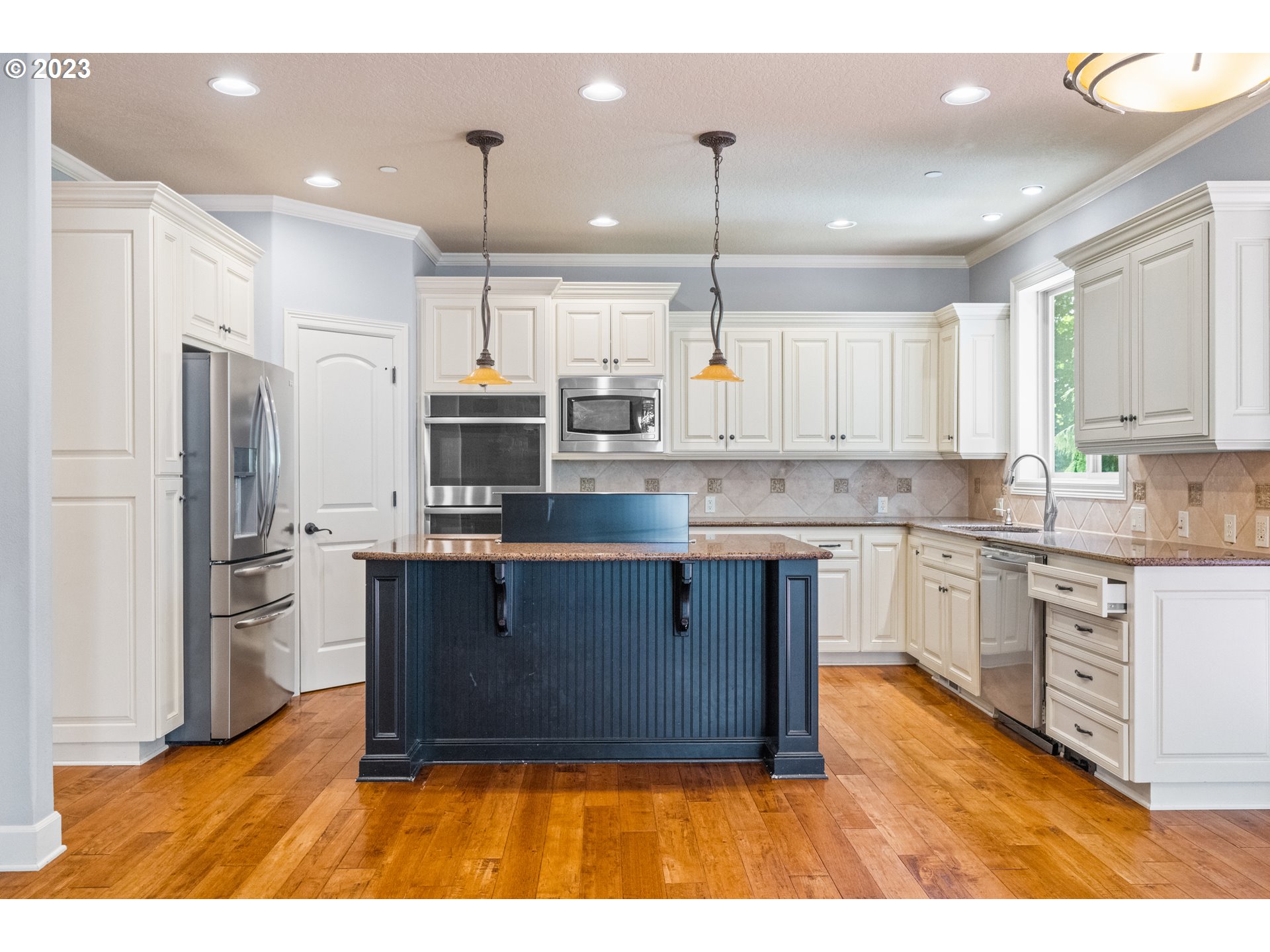 18281 Southwest Florendo Lane Beaverton, OR 97007 - Photo 13 of 47 a kitchen with stainless steel appliances granite countertop a refrigerator a stove a sink and a wooden floors