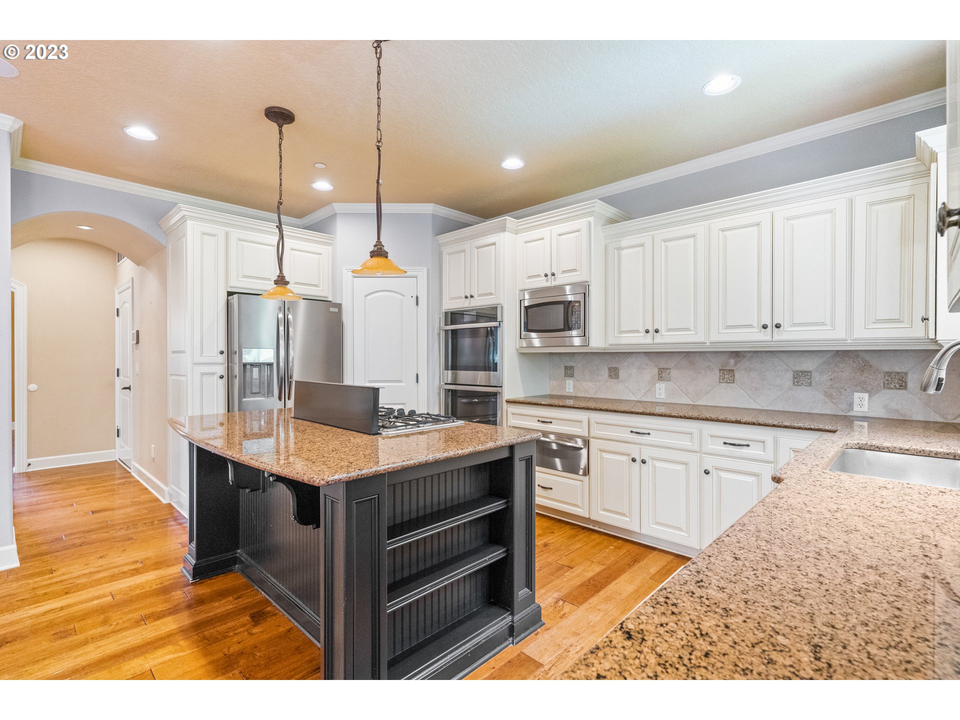 18281 Southwest Florendo Lane Beaverton, OR 97007 - Photo 14 of 47 a kitchen with stainless steel appliances granite countertop a sink a stove and a refrigerator
