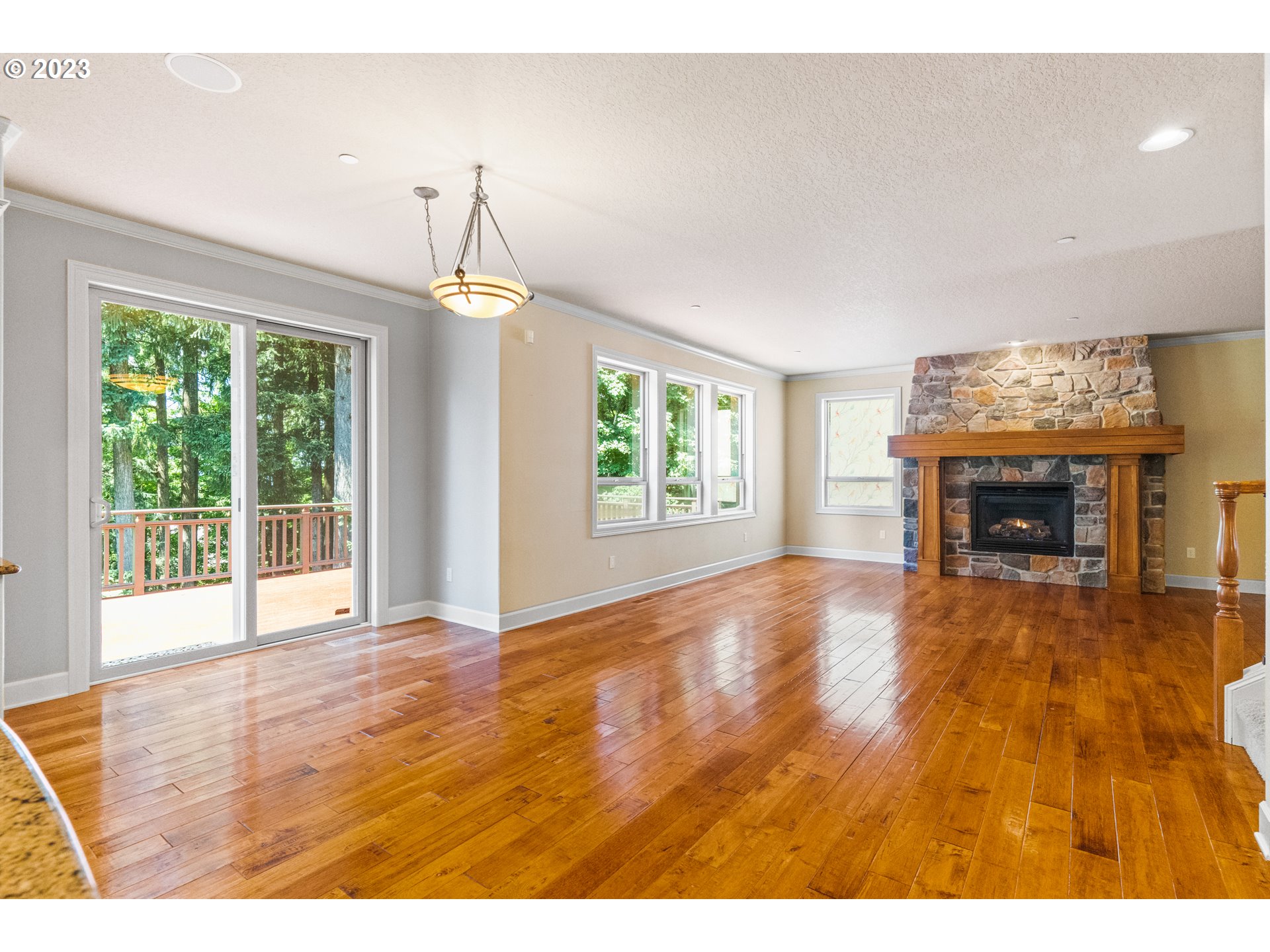 18281 Southwest Florendo Lane Beaverton, OR 97007 - Photo 17 of 47 a view of an empty room with wooden floor fireplace and a window