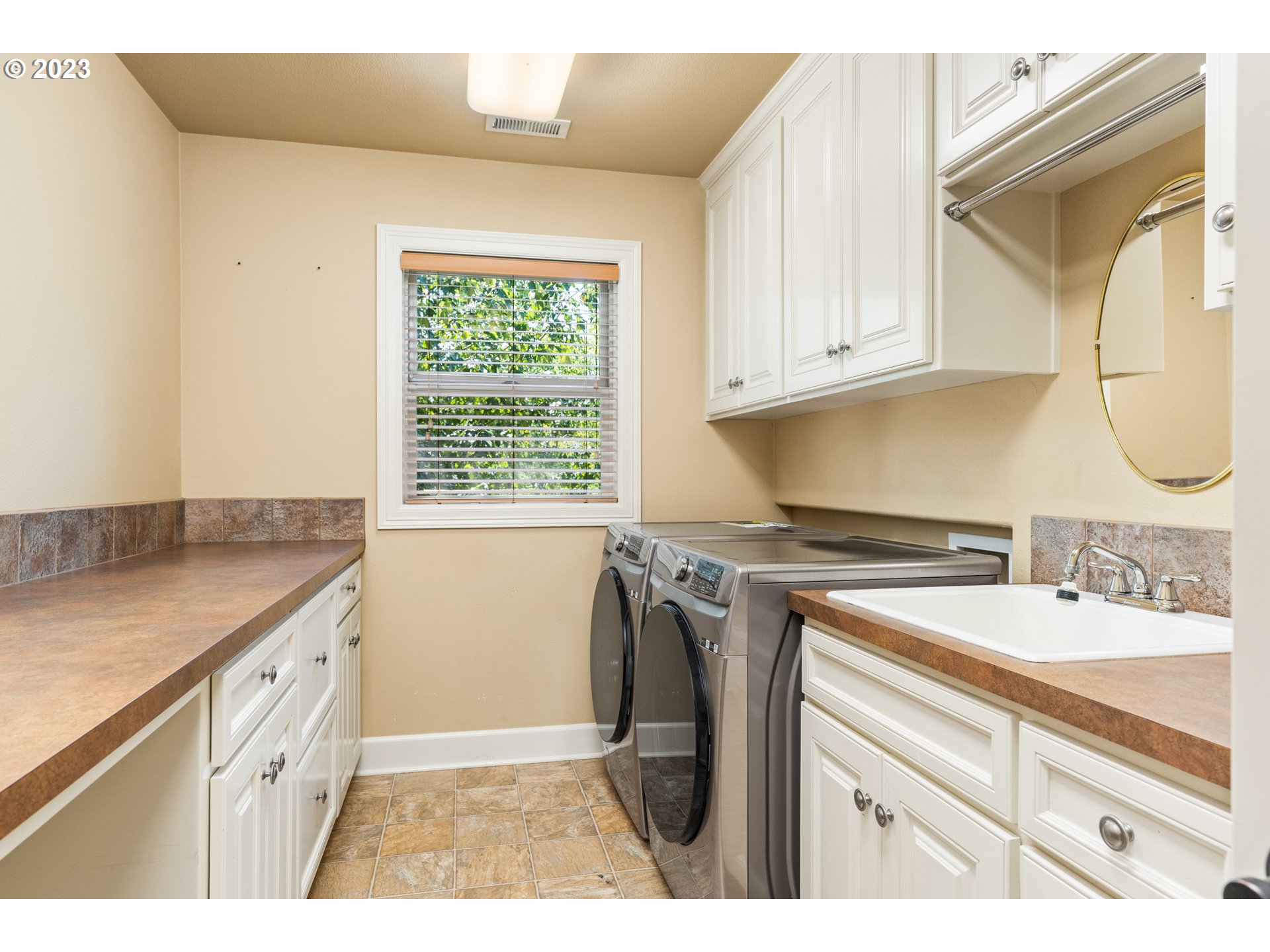 18281 Southwest Florendo Lane Beaverton, OR 97007 - Photo 30 of 47 a kitchen with a sink cabinets and a window