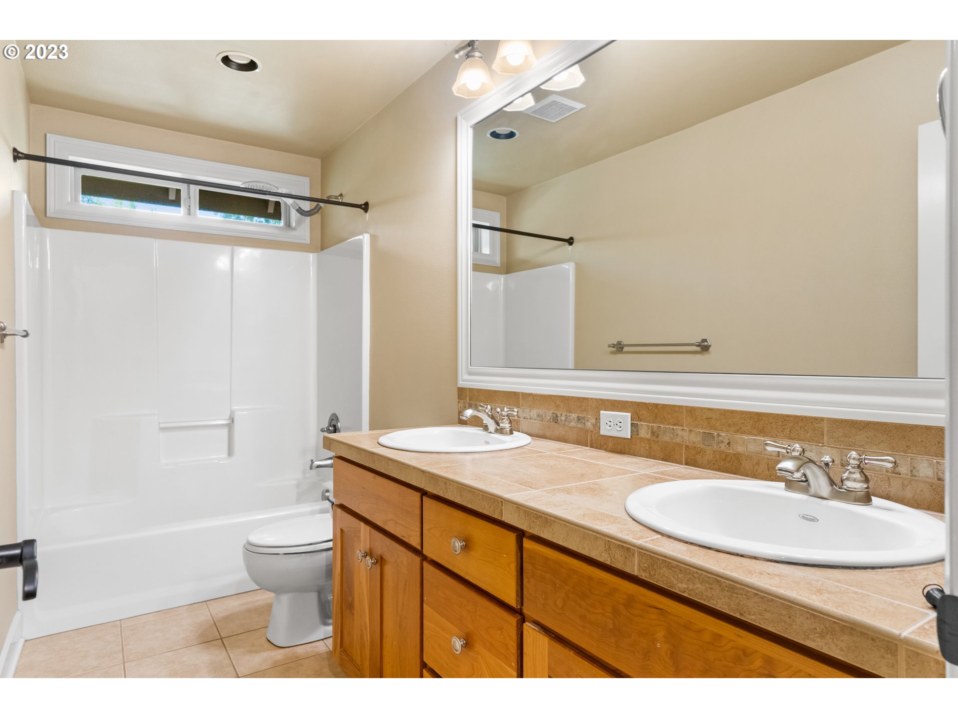 18281 Southwest Florendo Lane Beaverton, OR 97007 - Photo 31 of 47 a bathroom with a sink a toilet a mirror and shower