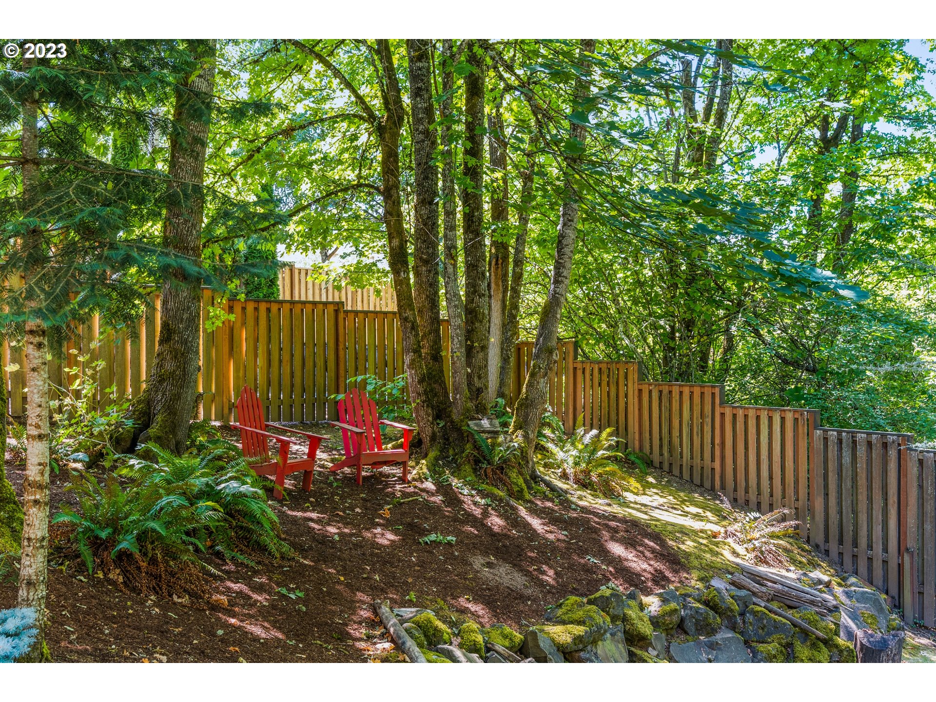 18281 Southwest Florendo Lane Beaverton, OR 97007 - Photo 46 of 47 a view of a backyard with plants and wooden fence