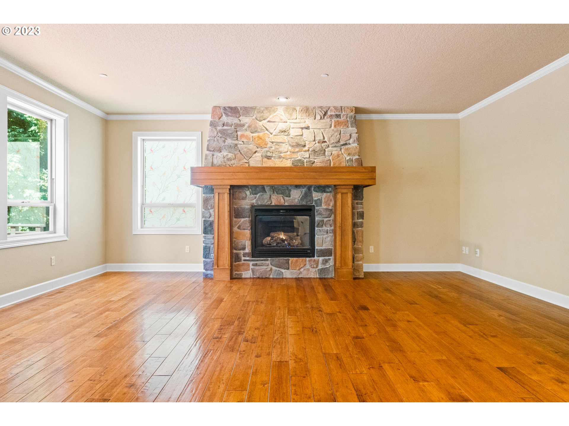 18281 Southwest Florendo Lane Beaverton, OR 97007 - Photo 10 of 47 a view of an empty room with a fireplace and a window