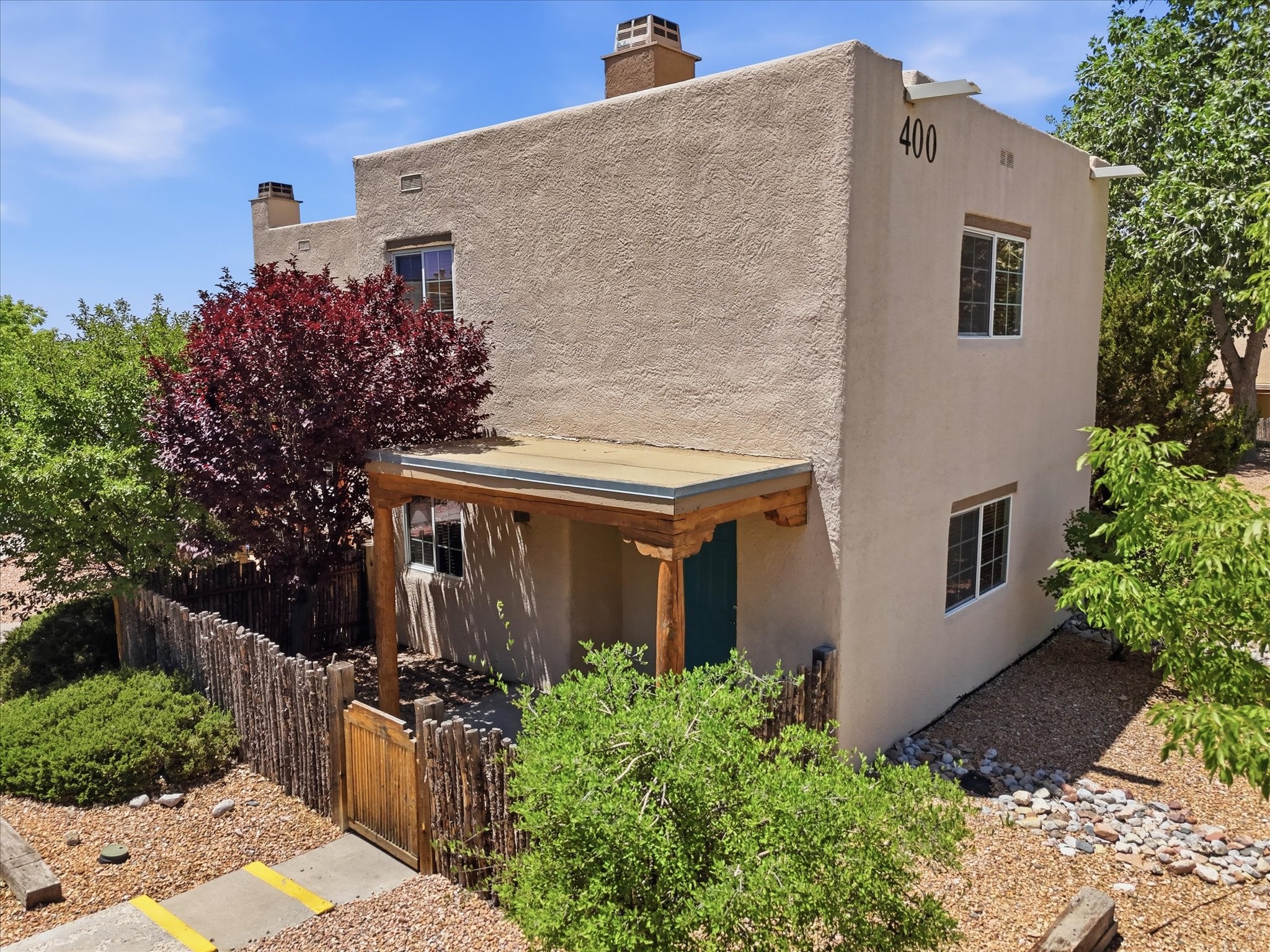 2210 Miguel Chavez Road, Unit 411 Santa Fe, NM 87505 - Photo 36 of 59 Facade of the unit with coyote fence for privacy