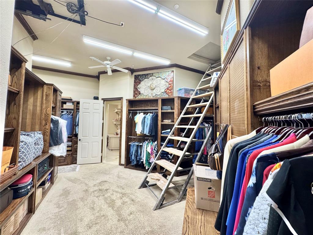 1634 Oak Ridge Drive Corinth, TX 76210 - Photo 11 of 40 a view of walk in closet with clothes and shoes