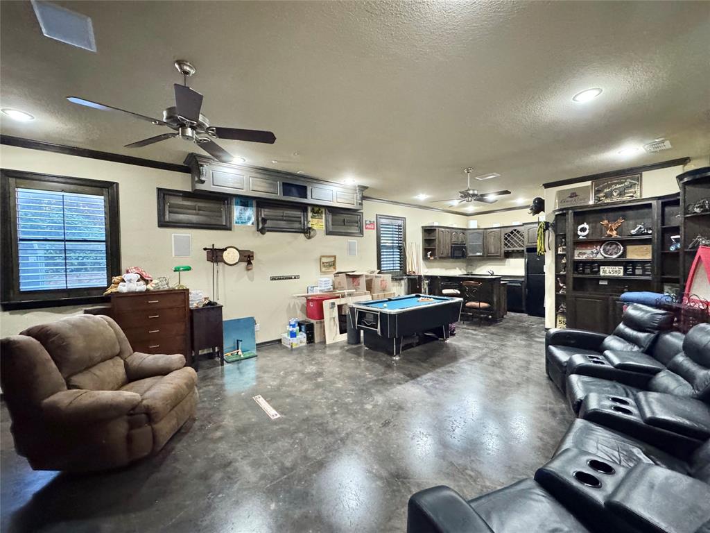 1634 Oak Ridge Drive Corinth, TX 76210 - Photo 31 of 40 a living room with furniture a ceiling fan and a window
