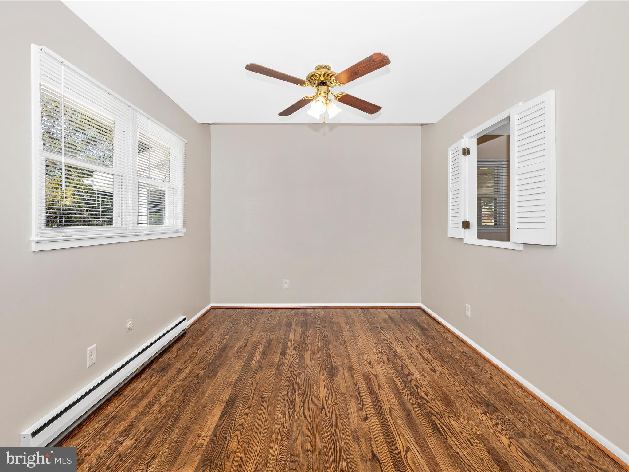 20731 Emerald Drive Hagerstown, MD 21742 - Photo 11 of 54 an empty room with wooden floor fan and windows