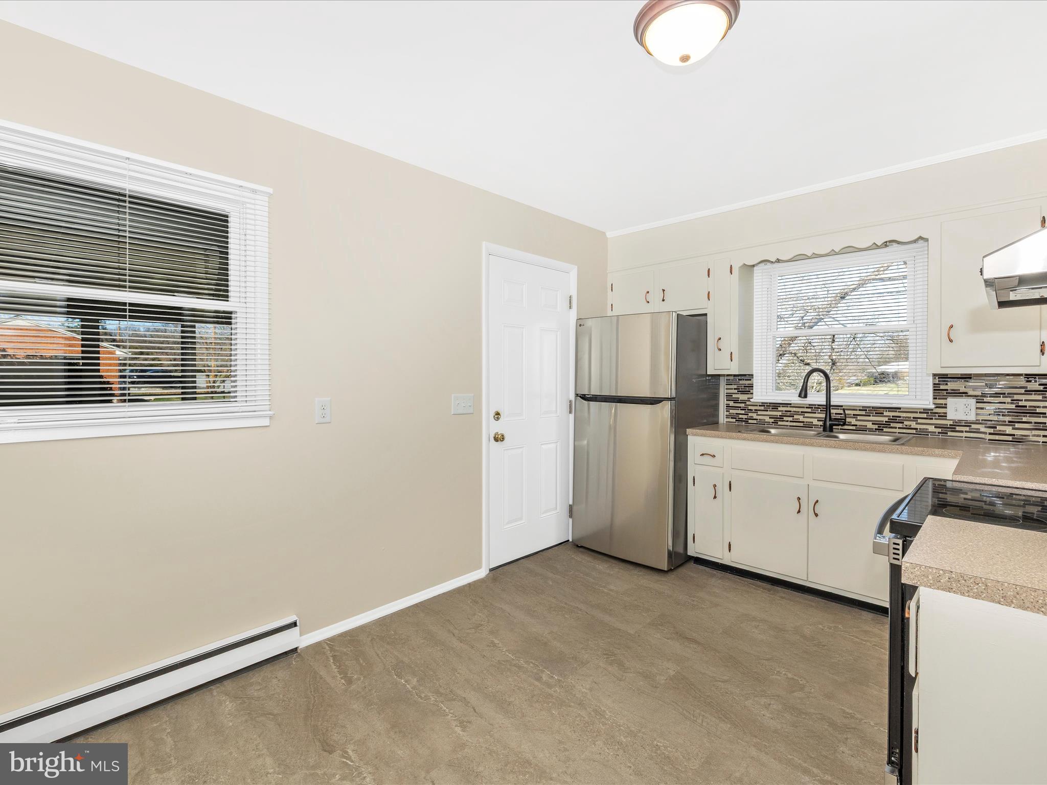 20731 Emerald Drive Hagerstown, MD 21742 - Photo 13 of 54 a kitchen with refrigerator and cabinets