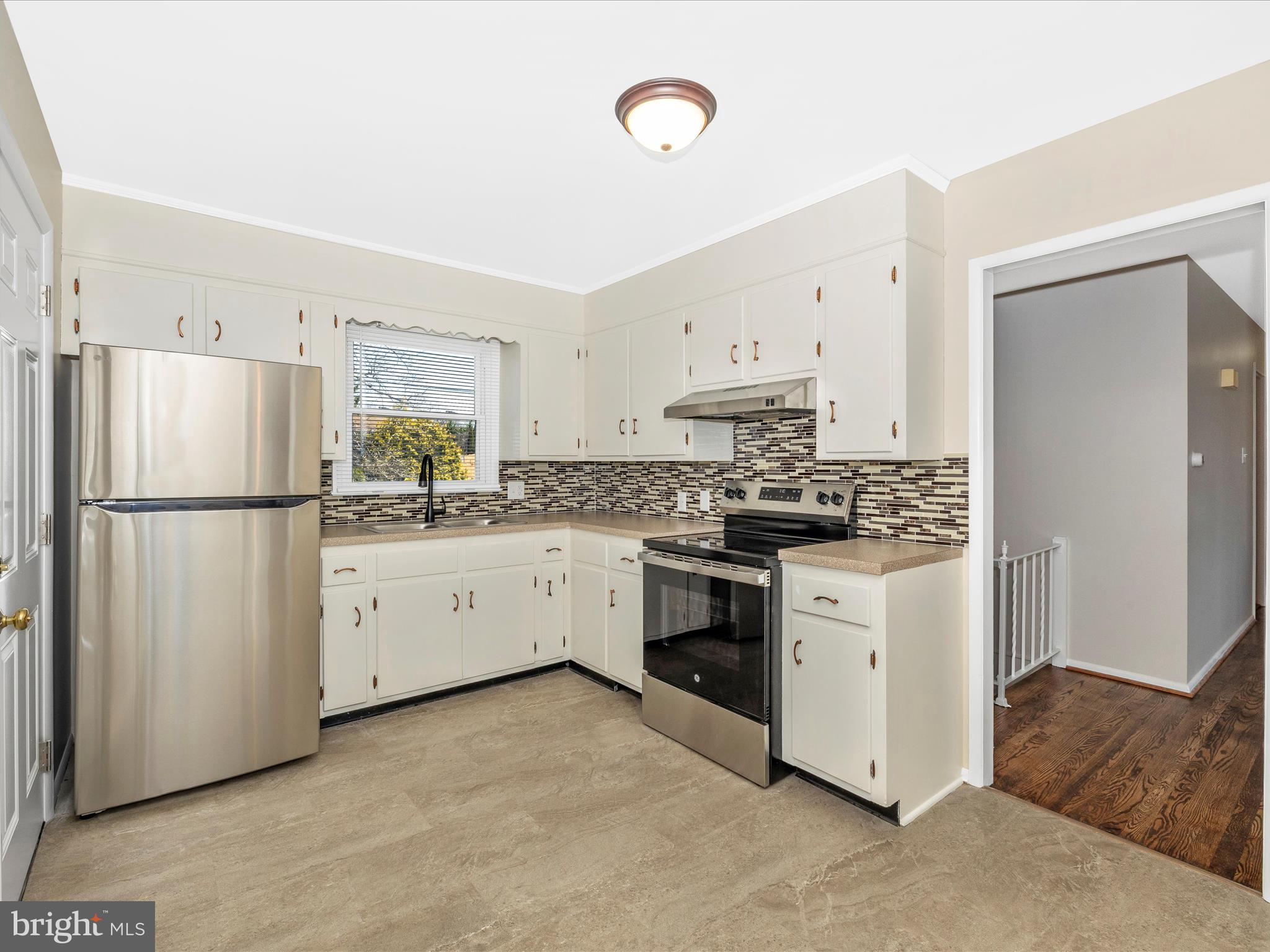 20731 Emerald Drive Hagerstown, MD 21742 - Photo 15 of 54 a kitchen with white cabinets and white appliances