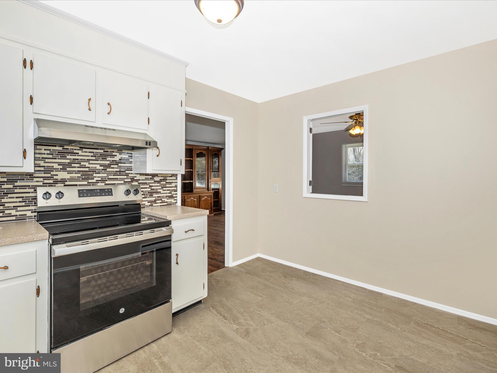 20731 Emerald Drive Hagerstown, MD 21742 - Photo 16 of 54 a kitchen with white cabinets and stainless steel appliances