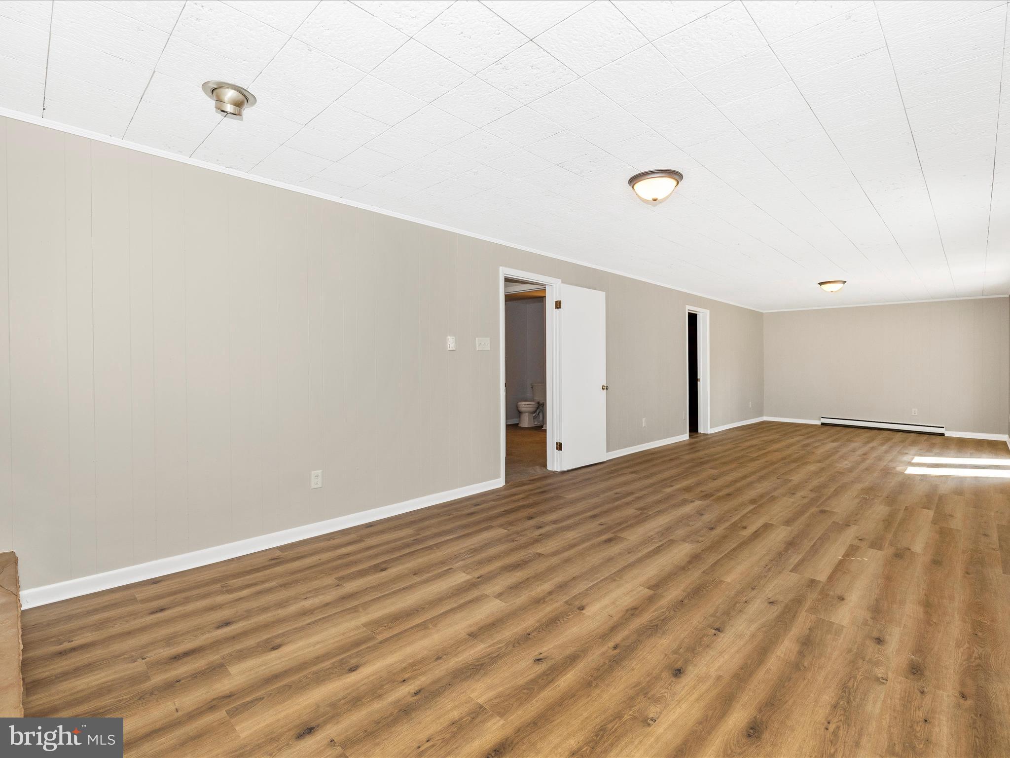 20731 Emerald Drive Hagerstown, MD 21742 - Photo 31 of 54 a view of empty room with wooden floor