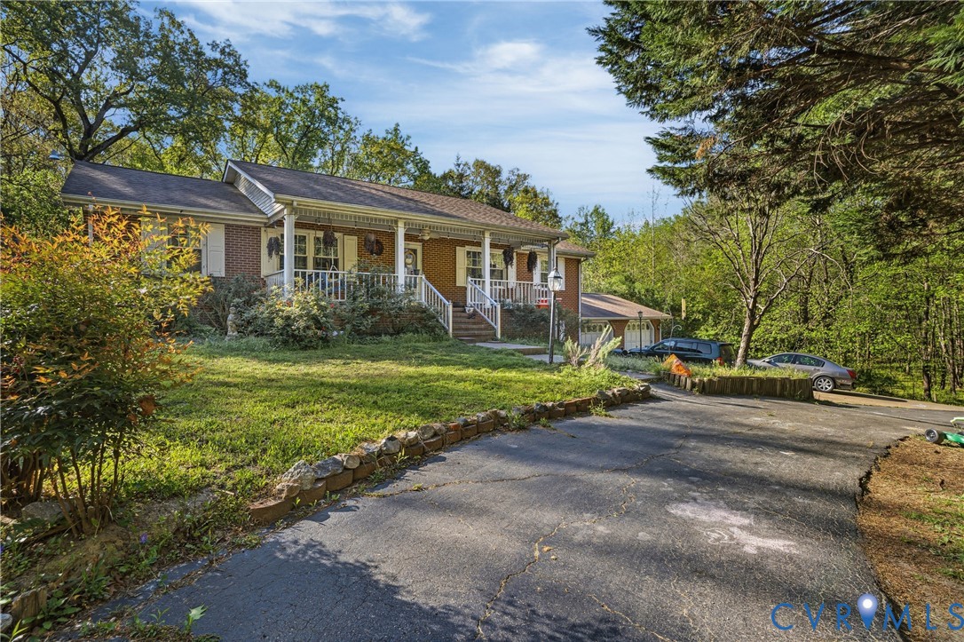 14219 Spruce Avenue Chester, VA 23836 - Photo 2 of 32 a view of a house with backyard and sitting area