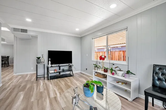 a kitchen with stainless steel appliances a refrigerator sink and wooden floor