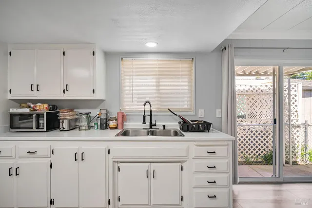 a view of a room with furniture and wooden floor