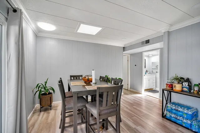 a large kitchen with a table and chairs