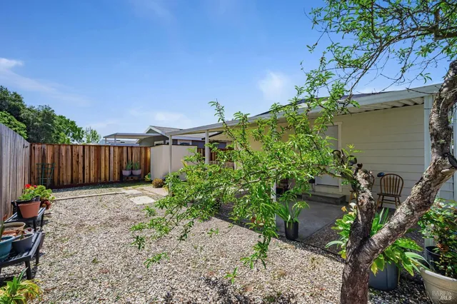a view of a patio with table and chairs and potted plants