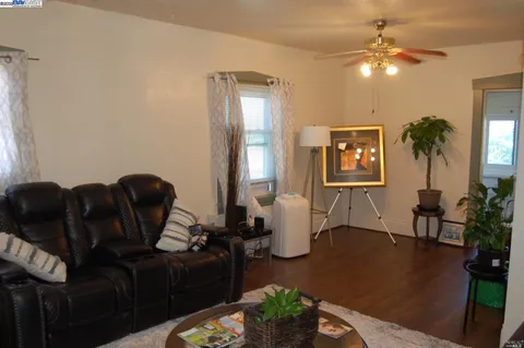 a living room with furniture a chandelier and a window