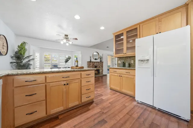 a kitchen with stainless steel appliances white cabinets and wooden floors