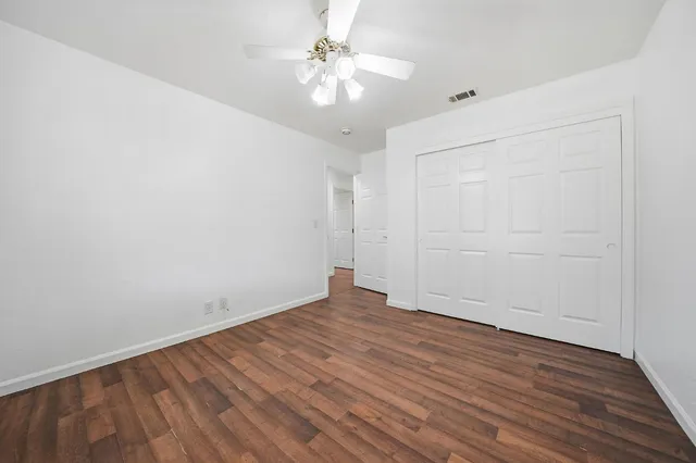 a view of a hallway with wooden floor and entryway